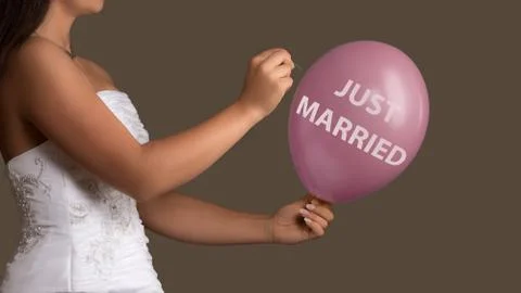 Bride lets a Balloon with Text burst with a needle Stock Photos
