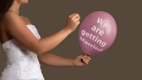 Bride lets a Balloon with Text burst with a needle Stock Photos