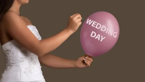 Bride lets a Balloon with Text burst with a needle Stock Photos