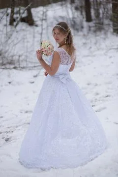 Bride Looking Back In Snowy Forest Stock Photos