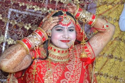 The bride looking at the camera and touch her jewelry with smiley face Stock Photos