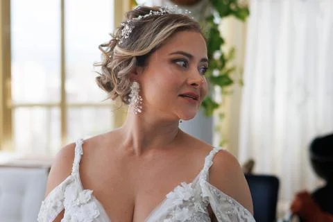 Bride looking at herself in the mirror Фото