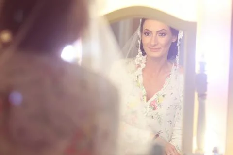 Bride looking in the mirror Stock Photos