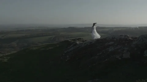 Bride looking out over windy cliff Stock Footage 38838924