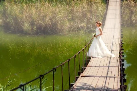 Bride looking at the river on bridge Stock Photos