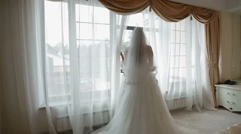 Bride looking through the window Stock Footage 50492231