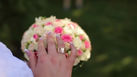 The bride is looking at the wedding bouquet 스톡 동영상 82827595