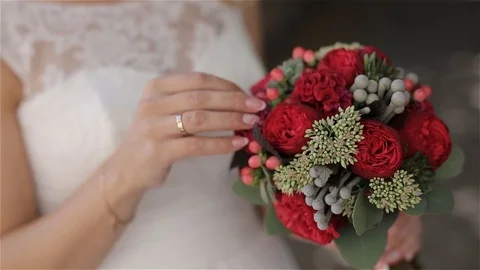 The bride is looking at the wedding bouquet Stock Footage 98855342