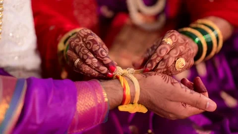 Bride Mehendi Hands Applying Haldi (Turmeric) on Groom Hand India Wedding Ritual 库存影片 162367329