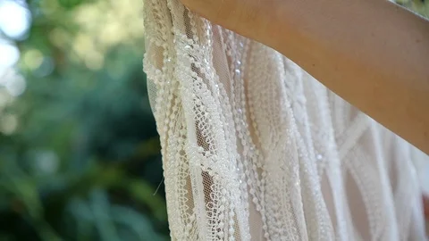 Bride moving her hand on her wedding dress, close up shot in slow motion. Vidéo 126522227