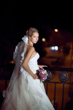 Bride at night by the railing Stock Photos