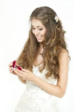 Bride opening red box with wedding rings. white isolated Stock Photos