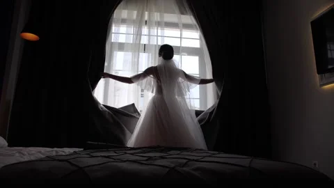 The bride opens the curtains in the room Stock Footage 172139025