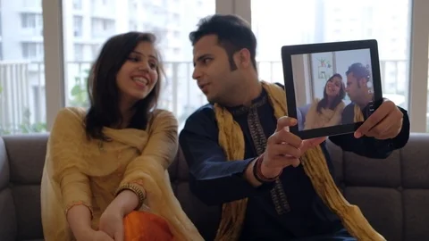 Bride in playful mood while husband tries to take selfie of theirs on a communic Stock Footage 100631481