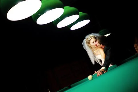 Bride playing billiard at night Foto stock
