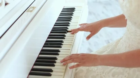 Bride plays the white piano Stock Footage 46478960