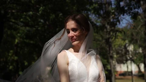 The bride poses for the camera with a veil. Stock Footage 130179965
