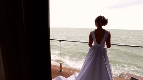 Bride posing at balcony at sea resort hotel Stock Footage 71361946