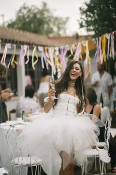 Bride Posing With Fan At Outdoor Reception Stock Photos
