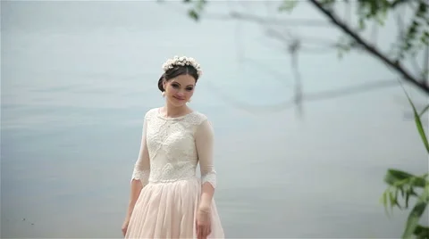 Bride posing on the river bank Stock Footage 66861376