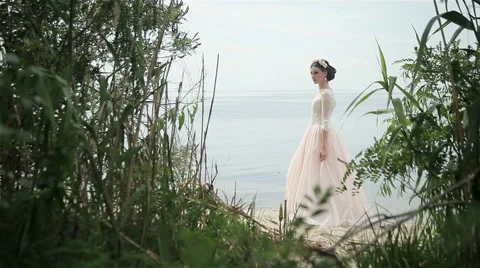 Bride posing on the river bank Video stock 66861503