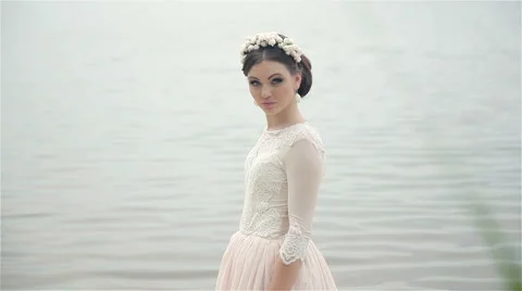 Bride posing on the river bank Stock Footage 66861788