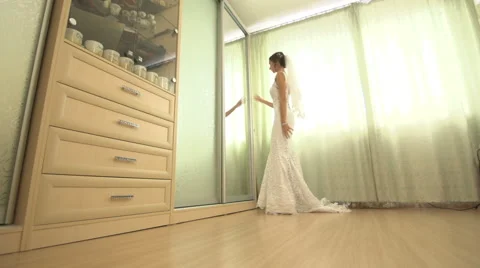 The bride preening before the mirror runs past the bald cat and all this during Stock Footage 61860554