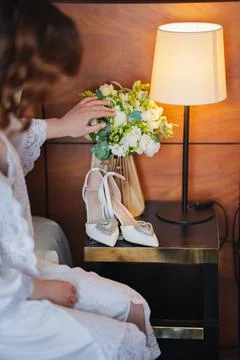 Bride preparing for wedding day with elegant shoes and bouquet Stock Photos
