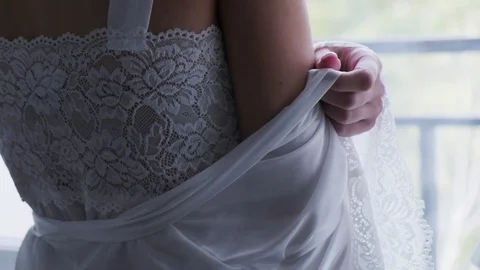 The bride is preparing for the wedding in a hotel room, stroking her shoulder Video stock 127341118
