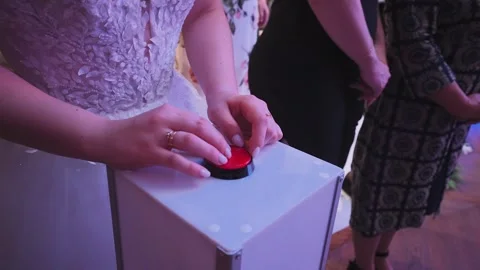 A bride presses a button in a wedding contest 스톡 동영상 328047942