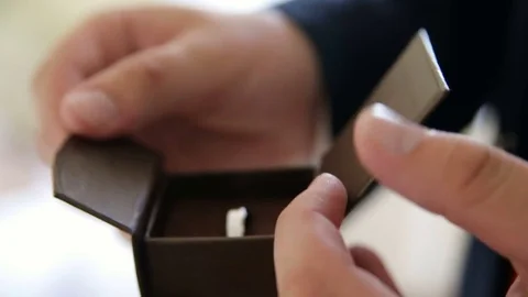The bride pulls the ring out of the box, looking up and puts back Stock Footage 70382953