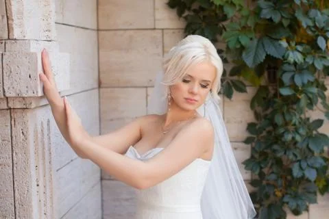 The bride put her hands on the wall texture Stock Photos