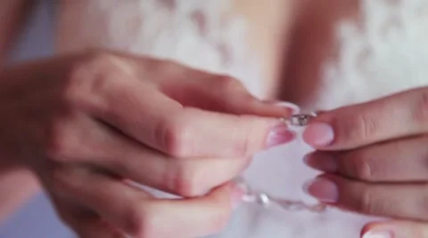 The bride puts on the hand bracelet Stock Footage 57482909