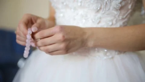 The bride puts the necklace on her arm Stock Footage 77230790
