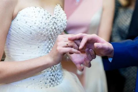 Bride puts ring on groom, close-up, wedding ceremony Stock Photos