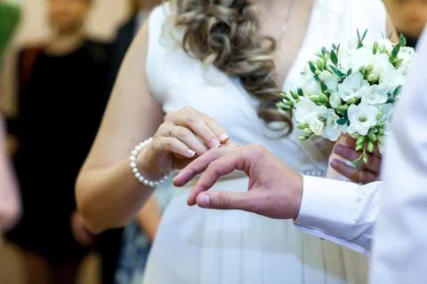 Bride puts ring on groom, close-up, wedding ceremony Stock Photos