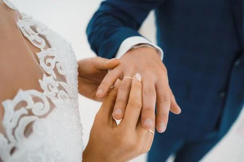 The bride puts on the ring to the groom, close-up Stock Photos