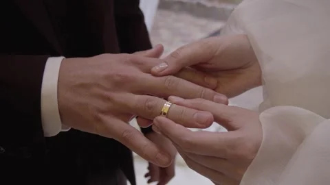 The bride puts a ring on the groom's finger at the wedding ceremony. Stock Footage 257618937