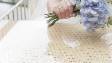 Bride puts the wedding flowers on the table Stock Footage 81653516