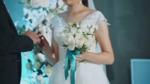 The bride puts on the wedding ring to the groom 스톡 동영상 229422873