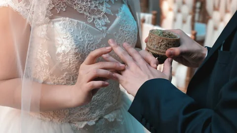 The Bride Puts The Wedding Ring On The Groom's Finger At The Wedding. Stock Footage 198349751