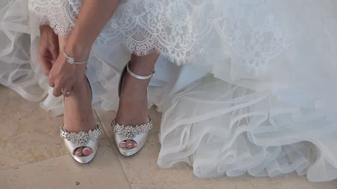 Bride puts on wedding shoes Stock Footage 97529272