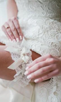 The bride putting on garter Stock Photos