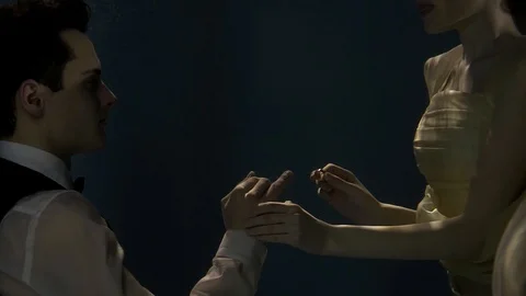 Bride is putting golden ring on hands of her loving groom, wedding underwater Video stock 88888965