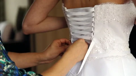Bride putting on her white wedding dress Stock Footage 58190439