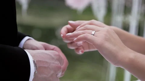 Bride putting wedding ring on brides finger close up summer day no face slow. Stock Footage 131653842