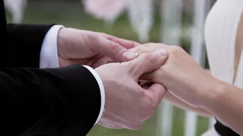 Bride putting wedding ring on brides finger close up summer day no face slow. Stock Footage 131654088