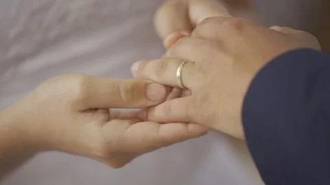 Bride putting a wedding ring on her husband during the wedding ceremony Stock Footage 111409655