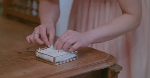 Bride putting wedding rings in decorated box Stock Footage 80893267