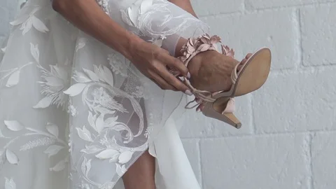 Bride Putting on Wedding Shoes Stock Footage 121010045